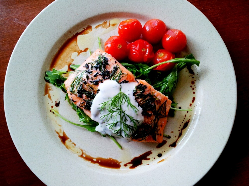 Lemon and Herbs Baked Norway Salmon, Dill Yoghurt Sauce, Wild Rocket, Roast Cherry Tomatoes.