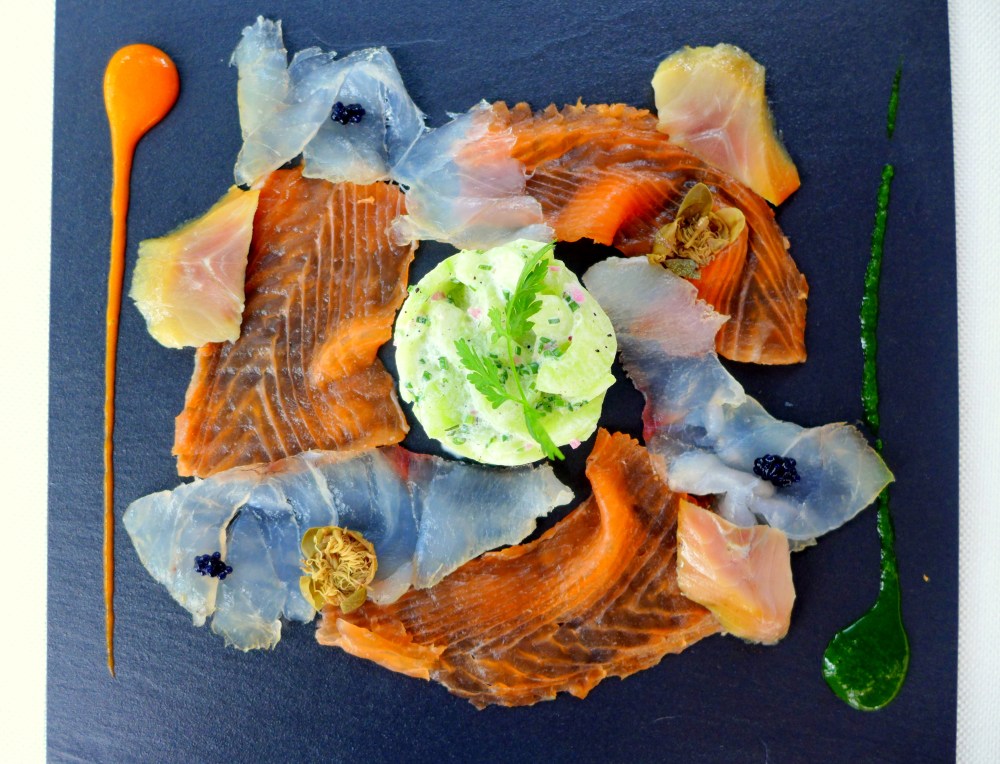 Homemade smoked fish platter, salmon, herring, sea bass  with  cucumber salad  and champagne vinegar