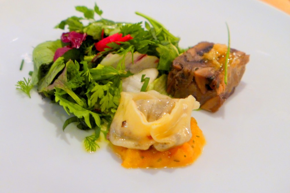 Roasted portobello pave with smoked garlic vinaigrette, mushroom tortellini with tomato fondue and herb salad