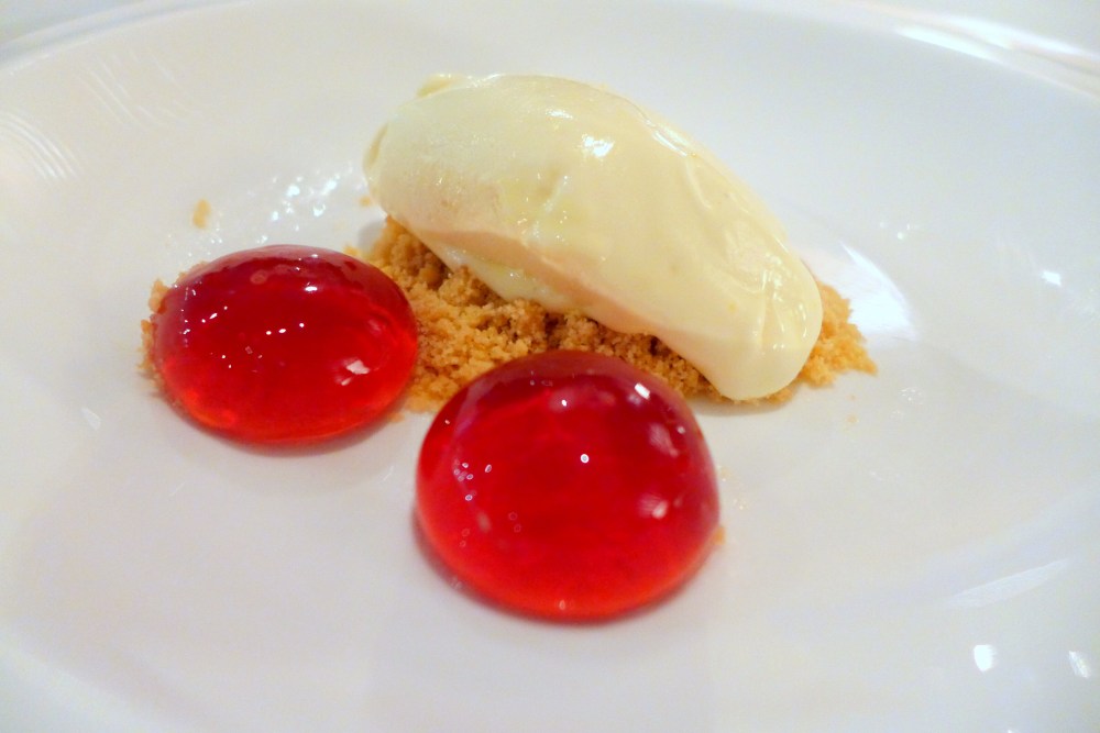 Coconut ice cream with blackcurrent spheres